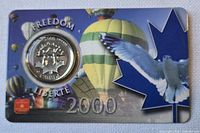 Front of card with coin in blister, Freedom-Liberté text, balloons background