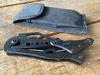 Knife folded next to nylon sheath