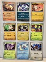 Front view of nine sleeved Pokémon cards arranged in binder page showing characters, HP, types and sleeve condition