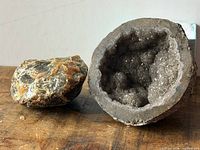 Amber chunk and geode half side by side on tabletop