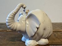 Full view of porcelain elephant figurine with mouse