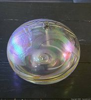 Full view of spherical iridescent glass oil lamp