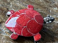 Front view showing red coral inlay turtle brooch