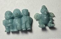 Two vintage blue/aqua Mario rubber erasers—one triple character, one winged