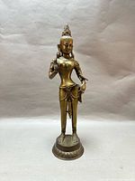 Full view of bronze standing deity statue on lotus base