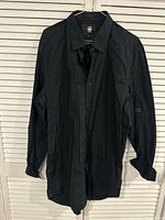 Front view of black G-Star RAW long-sleeve shirt on hanger
