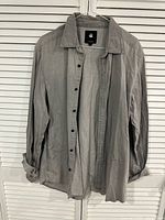 Full view of grey G-Star RAW long-sleeve shirt on hanger, front open