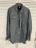Front view of G-Star RAW pinstripe shirt on hanger