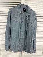 Front view of G-Star RAW pinstripe shirt hanging