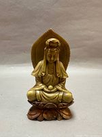 Front view of carved soapstone Guan Yin statue on lotus base with halo