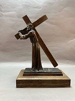 Full left profile of statue on base