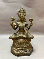 Front view of brass Lakshmi statue
