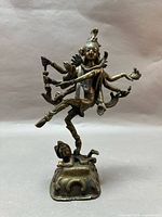 Front view of cast metal Shiva Nataraja statue on pedestal