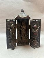 Altar open showing three carved figures