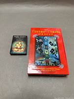 Front view of both boxed decks: Tantric Dakini Oracle (red) and Buddha Wisdom Shakti Power (black)