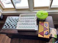 Glass checkerboard, styrofoam tray with green shot glasses, Chinese checkers board, cribbage board box, plastic bowl of chess pieces