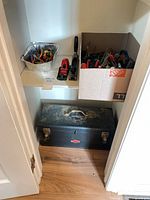 Overview of toolbox, hand plane, containers of assorted tools