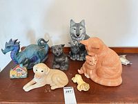 Group shot of eight ceramic figures on wooden surface