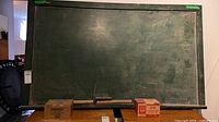 Front view of chalkboard with chalk boxes and erasers
