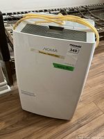 Front view of white Noma dehumidifier with carry handle and vents