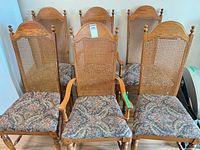 Front view of six wood cane back dining chairs