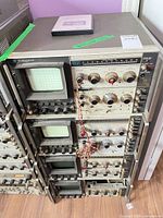 Front view of stacked Tektronix oscilloscope mainframes with CRTs and plug-in modules