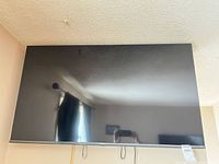 Front view of Hisense 50-inch TV mounted on wall
