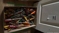Closed box filled with assorted screwdrivers