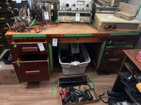 front view of desk with drawers partly open showing layout and wear