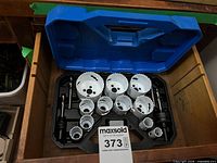 Open case showing complete set of hole saws and mandrels