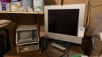 Samsung 170MP LCD with remote, Curtis mini CRT TV sitting on Fluke multimeter