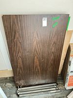 Rectangular laminate top and separate metal frame parts