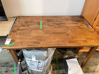 Top view of wooden table showing surface wear, scratches and overall design