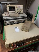 Stack of equipment showing Rigol oscilloscope on top of rack unit, DECserver 100 in foreground