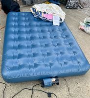 Inflated full-size AeroBed showing tufted top and built-in electric pump