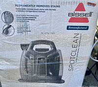 Box showing Bissell SpotClean cleaner with HeatWave Technology, remanufactured label and price tag