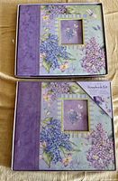 Two boxed floral scrapbook kits showing covers and packaging