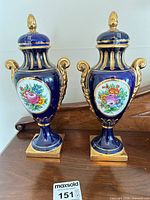 Both vases standing side by side on table