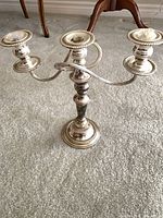 Three-arm silver candelabra standing view
