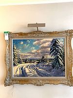 Front view of framed painting with picture light attached
