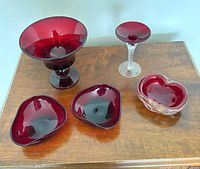 All five ruby red glass items on table