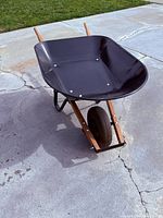 Full view of wheelbarrow showing tray, handles, tire
