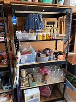 Full view of black metal shelf with four tiers