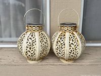 Front view of both round lattice metal solar lanterns