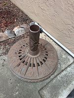 Full view of cast iron umbrella stand against wall