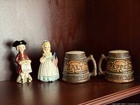 Full lot showing four ceramic shakers on shelf
