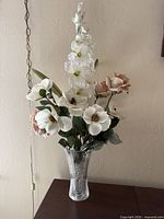 Full view of cut glass vase with white and blush faux flower arrangement