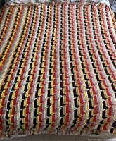 Full view of crochet afghan spread flat showing entire colour pattern