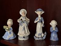 Front view of four porcelain figurines