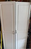 Front view of tall white two-door cabinet